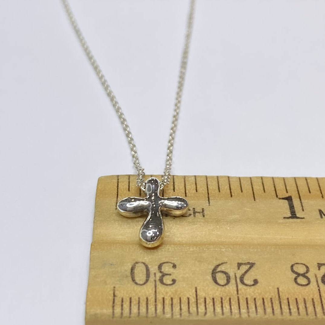 A Tiffany & Co. Silver and gold cross pendant, the groov… | Drouot.com